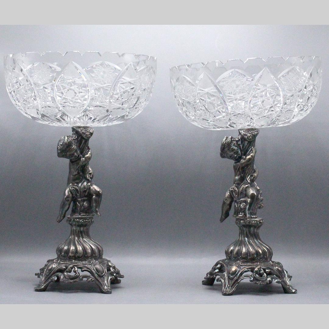 Pair Cut Glass Center Bowls on Putti Silver Plate Bases: Pair Cut Glass Center Bowls on Putti Silver Plate Bases. Size: 15 x 10 inches