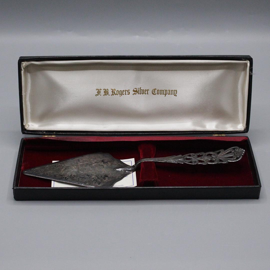 F B Rogers Silver Company Fancy Silver Plate Cake Knife: F B Rogers Silver Company Fancy Silver Plate Cake Knife. Original display box. Knife marked Made in Italy. Size: 1.75 x 12.75 inches in box, 12 inches length spatula