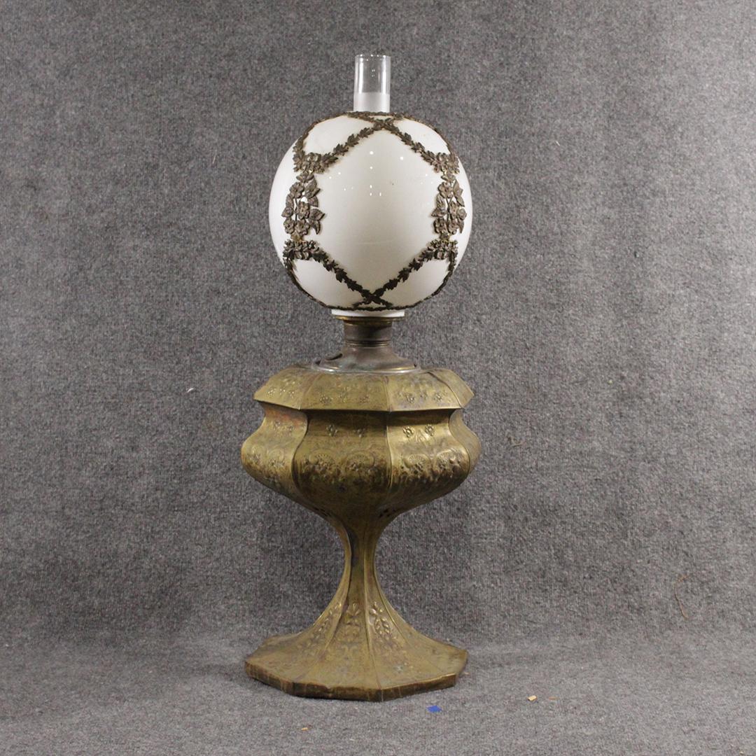Large 19th C. Victorian Relief Brass Banquet Lamp: Large 19th C. Victorian Relief Brass Banquet Lamp with White Glass Ball Shade having brass overlay decoration. Base has all over relief decoration. Size: 35 in. height, 12 in. wide