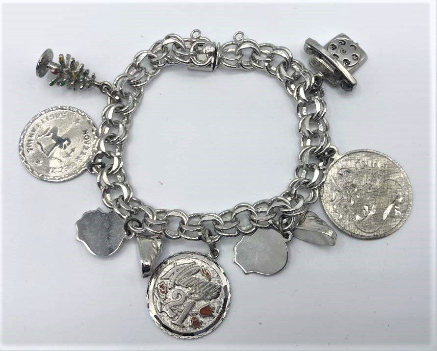 Sterling Silver Charm Bracelet with 9 Charms: Sterling Silver Charm Bracelet with 9 Charms. Size: 7.25 in. length.Weight: 1.25 oz.
