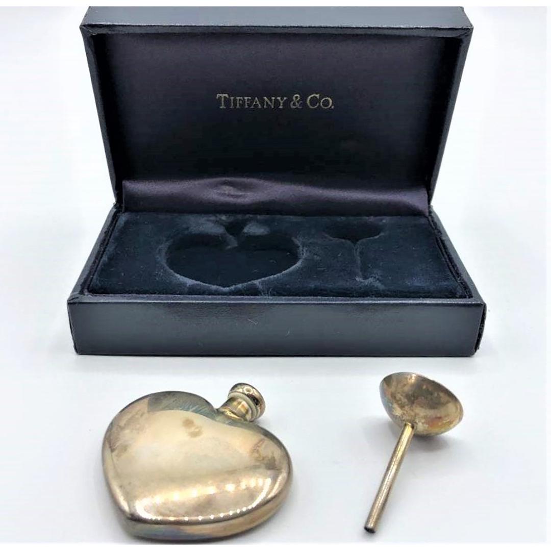 TIFFANY & CO 925 Sterling Heart Travel Perfume Bottle: TIFFANY & CO 925 Sterling Heart Travel Perfume Bottle with Funnel. Original Tiffany & Co. Fitted Box. Perfume bottle marked at neck: Tiffany & Co, 925, Sterling. Size: perfume bottle 1 5/8 in. x 1 5/8