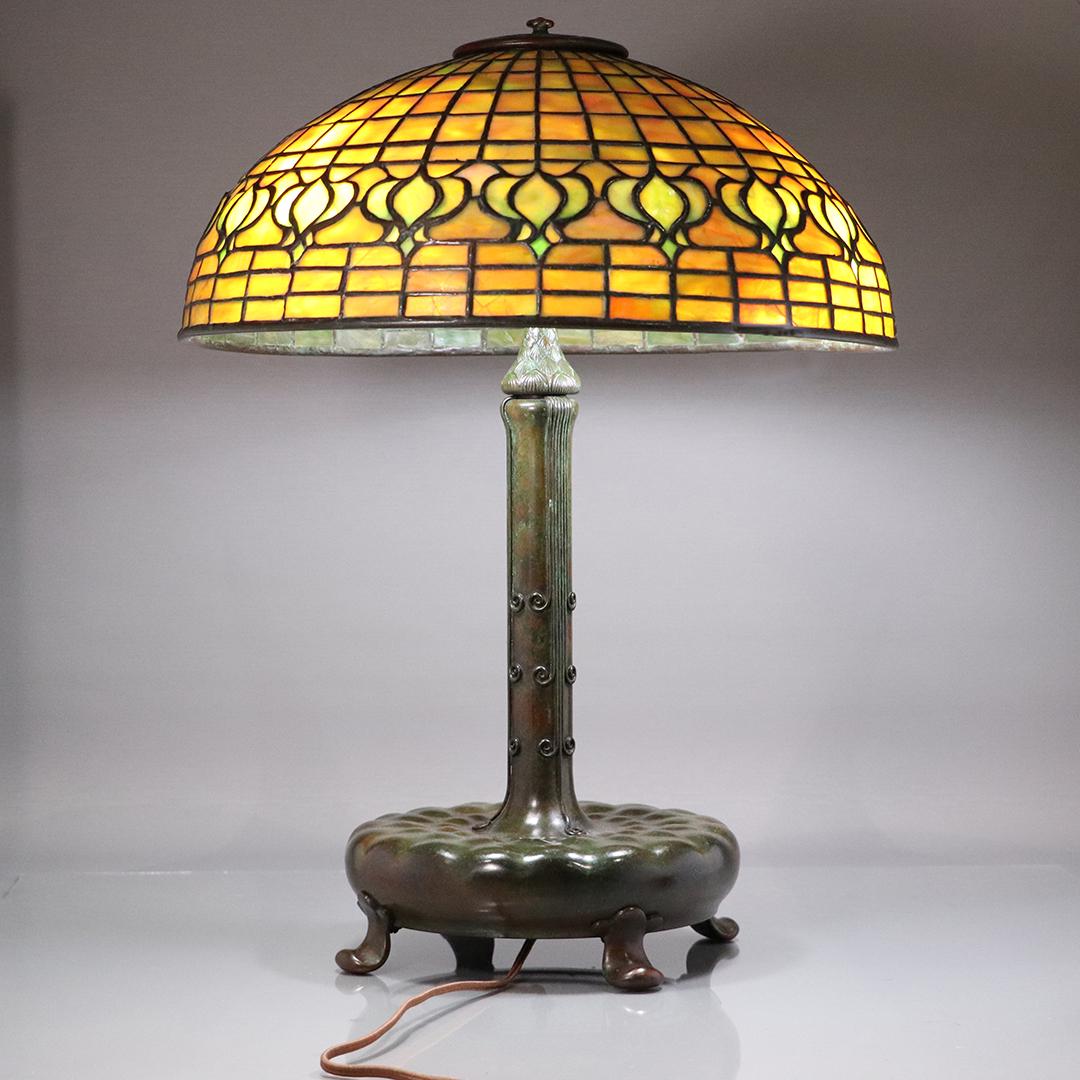 Tiffany Studios New York Pomegranate Dichroic Lamp: Tiffany Studios New York Pomegranate Dichroic Glass Shade Lamp. Signed Shade and Base: Tiffany Studios New York. Good bronze patina finish. Some minor cracks. Size: 20h, 16 inch shade Please visit our