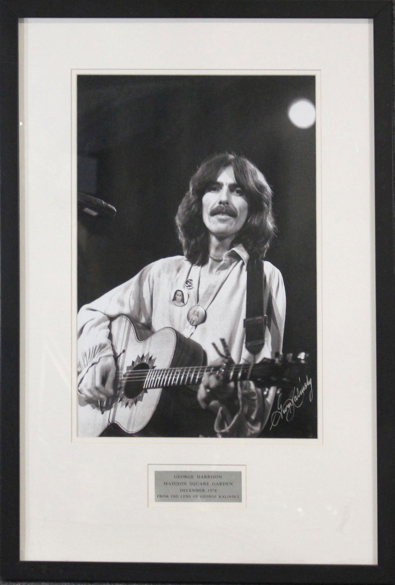 George Kalinsky Photograph of George Harrison MSG 1974: George Kalinsky Photograph of George Harrison MSG 1974. Framed and with Plaque. Size: 18 x 12 inches image, 28.5 x 19.5 inches outside frame