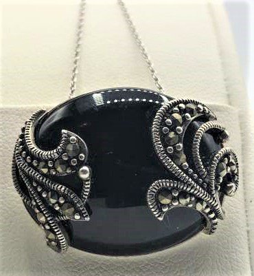 STERLING SILVER BLACK ONYX & MARCASITE PENDANT: STERLING SILVER BLACK ONYX & MARCASITE PENDANT WITH STERLING CHAIN. Size 18 in. length chain, pendant 1 1/8 in. x 7/8 in.