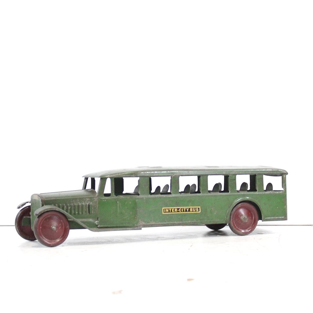 Antique Toy Pressed Steel Inter-City Bus in Green Paint: Antique Toy Pressed Steel Inter-City Bus in original Green Paint, decals have been replaced. Clean. Size: 6 in. height, 23.5 in. length, 6 in. wide.