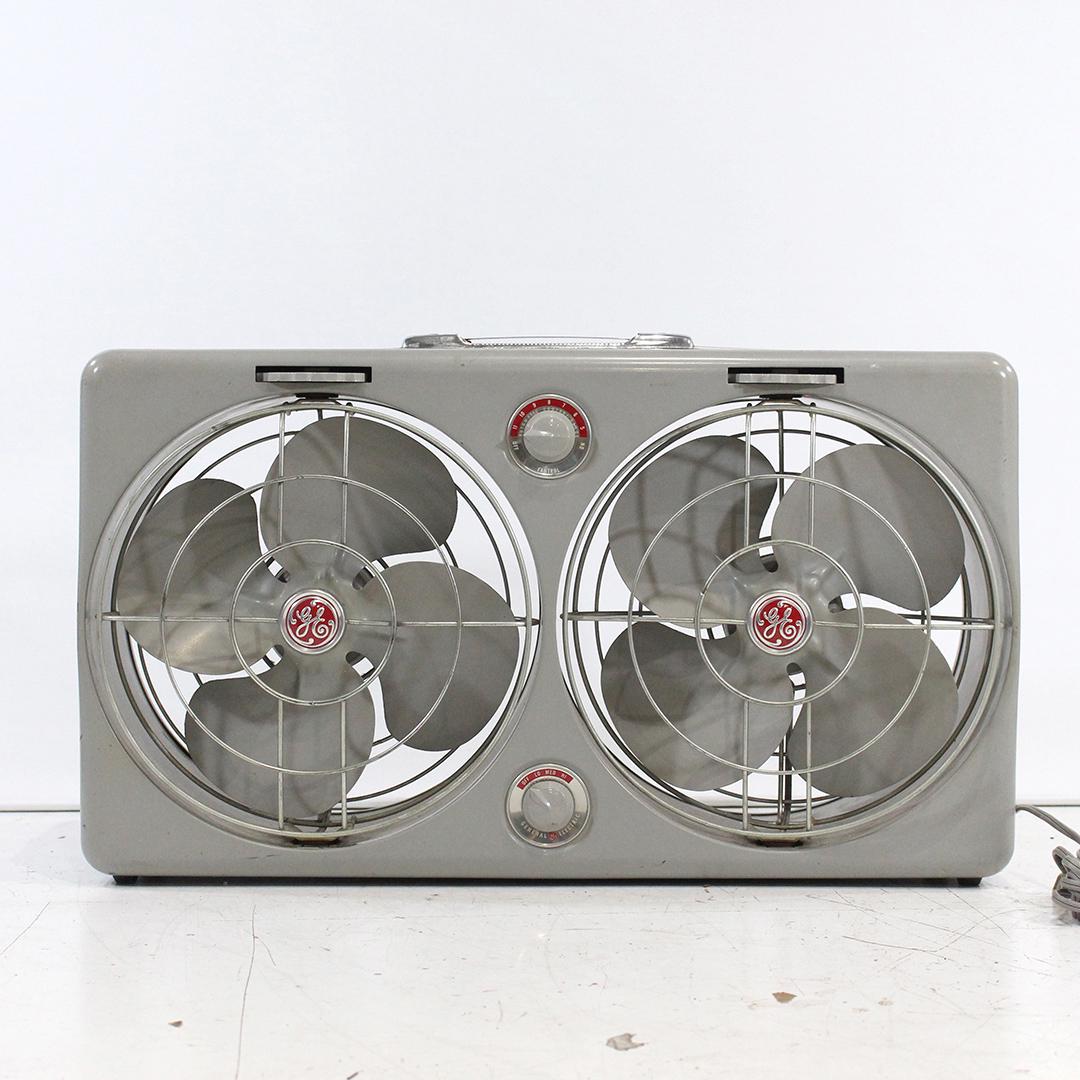 Mid-Century General Electric Suitcase Double Fans: Mid-Century General Electric Suitcase Double Fans, clean , working. Size: 16 in. height, 28 in. length.