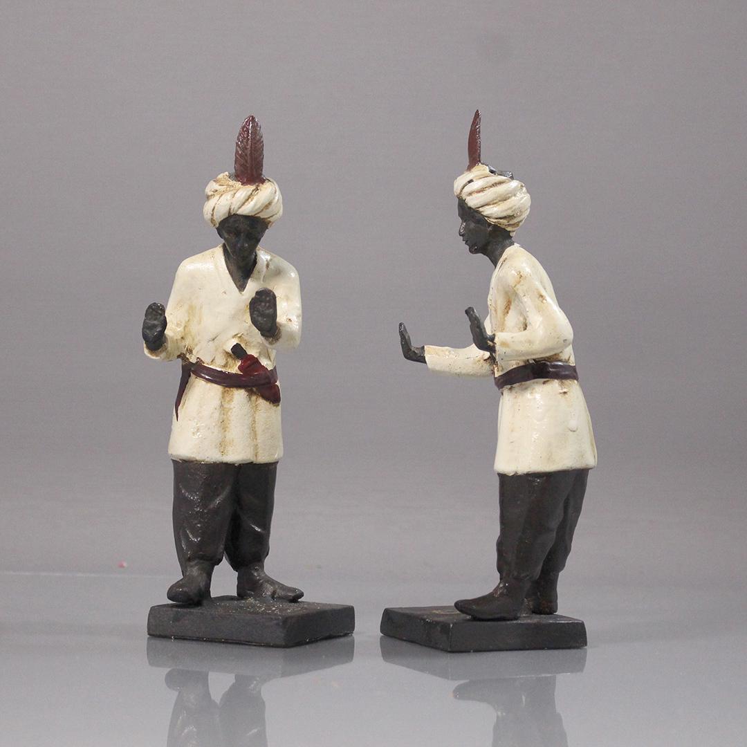 [2] Cast Iron Blackamoor Figures Doorstops / Bookends: [2] Cast Iron Blackamoor Figures Doorstops / Bookends. Original paint finish. Size: 8.5 in. height, 3 in. wide.
