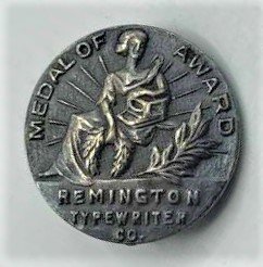 Sterling Silver Pin Remington Typewriter Medal of Award: Sterling Silver Pin Remington Typewriter Co., Medal of Award. Marked: Sterling ; Size: 3/4 in. diameter