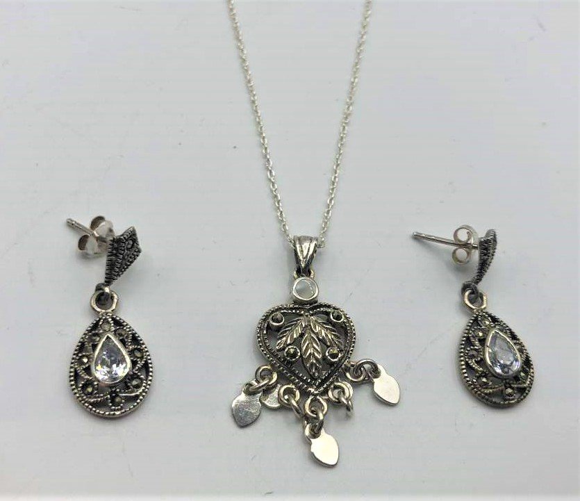 .925 Sterling Silver and Marcasites Necklace Earrings: .925 Sterling Silver and Marcasites Necklace Earrings. Heart Pendant 1 in. x 1/2 in. ; chain 18 in. length ; earrings 1 in. x 1/2 in. ; Marked: .925