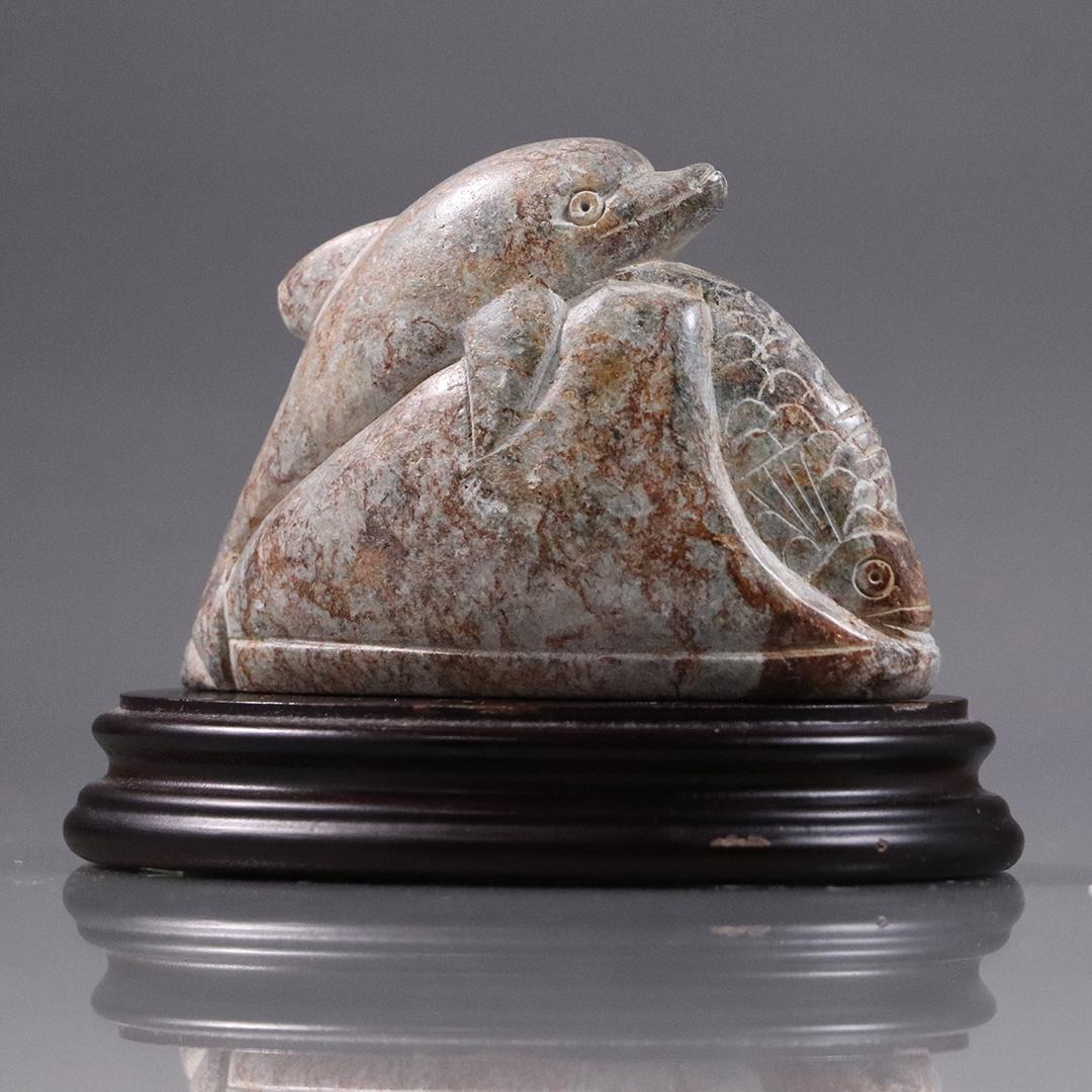 Carved Stone Dolphin and Fish Figurine on Wood Base: Carved Stone Dolphin and Fish Figurine on Wood Base. Size: 2.75 in. height x 4 in. stone without stand