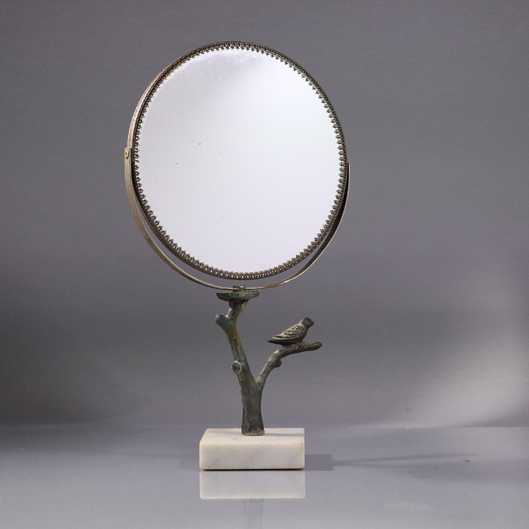 Giacometti Style Bronze Bird on Branch Make-Up Mirror: Giacometti Style Bronze Bird on Branch Make-Up Mirror. Mounted on white marble base, round swivel mirror. Size: 12.5 h , 7 w