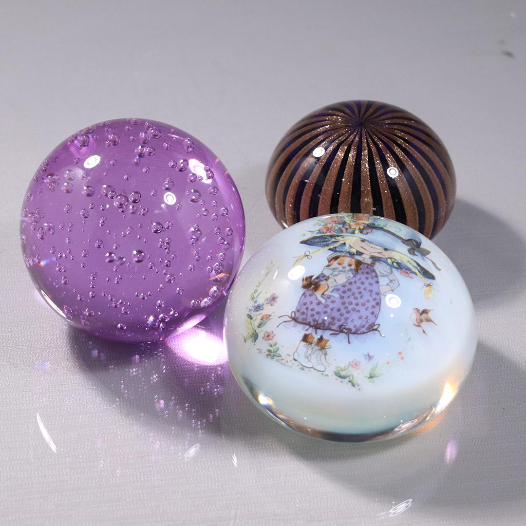 [3] Three Assorted Glass Paperweights, Gold Dust Murano: [3] Three Assorted Glass Paperweights, Gold Dust Murano, Purple Amethyst with Bubbles, Novelty with Young Girl. Size: 3.5 - 4 range inches width