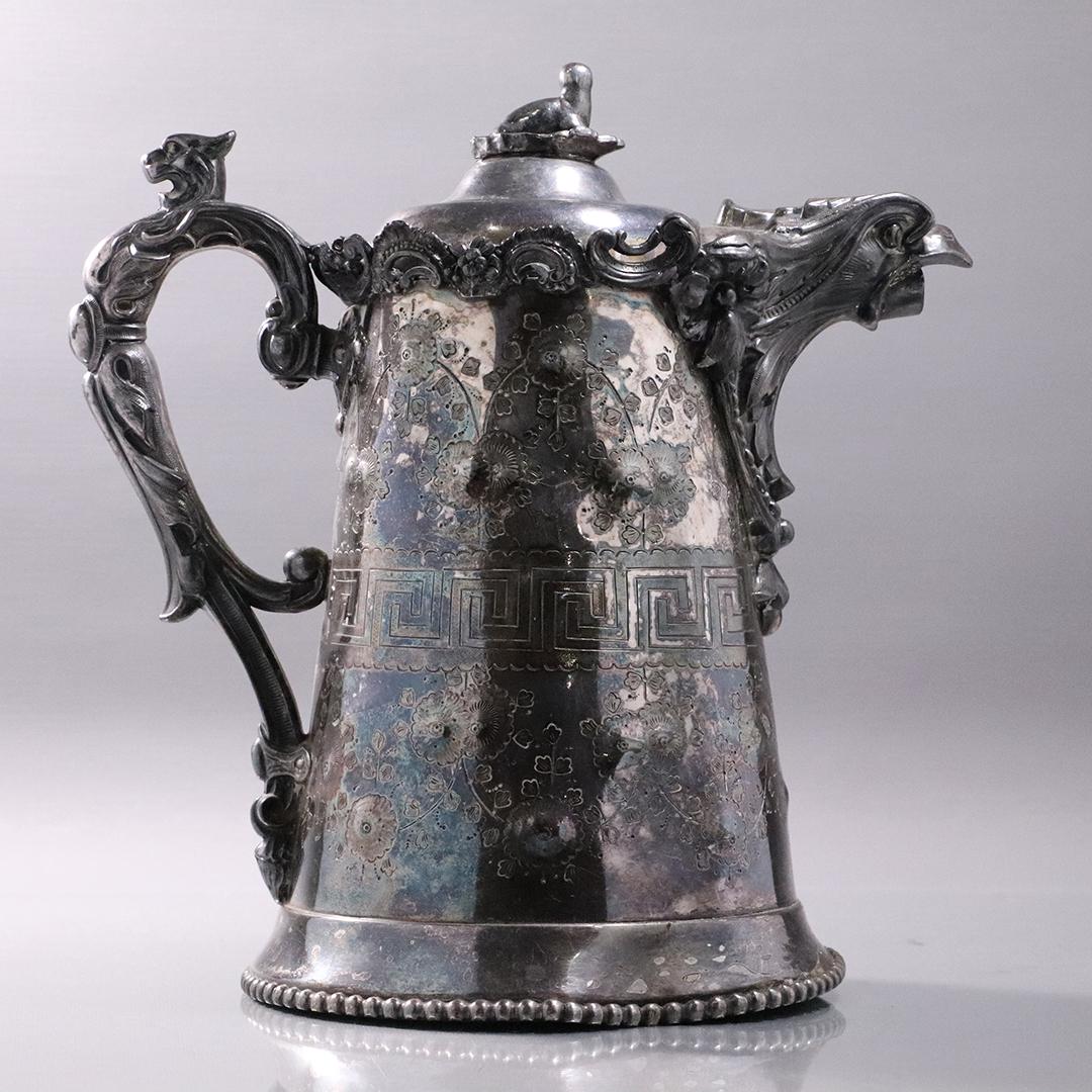 Unique King Arthur's Fancy Silver Plate Tankard Pitcher: Unique King Arthur's Fancy Silver Plate Tankard Pitcher. Eagle head spout, Seal finial top, Lion's head, Ornate incised decoration. Antique, 19th C. Victorian. Size: 12.5 in. height x 12 in. wide