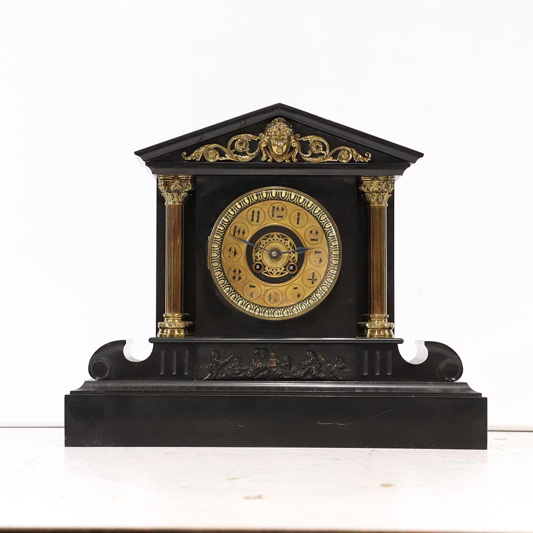 Edwardian Style Black Marble Mantle Clock Brass Columns: Edwardian Style Black Marble Mantle Clock Brass Columns, brass ladies head at crest and brass trim. Circa 1900. Brass movement. Size: 14 in. height x 18 in. length x 6 in. wide