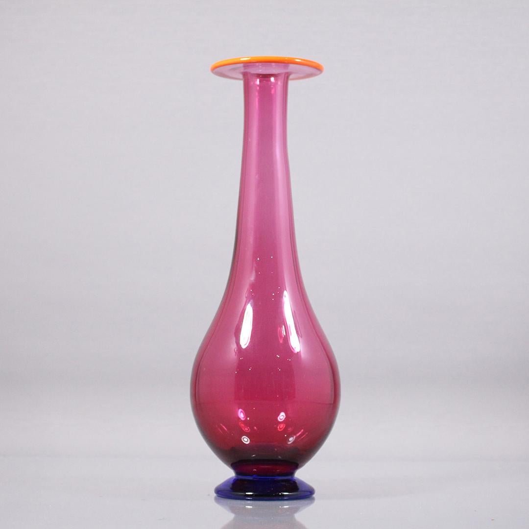 Erika Lagerbilke Orrefors Multi Colored Vase Signed: Artist: Erika Lagerbilke, Orrefors Multi Colored Modern Blown Glass Vase, bottom signed. Base is dark blue violet, body is pink / magenta, and the top is an orange accented rim. Pop art reminiscent of