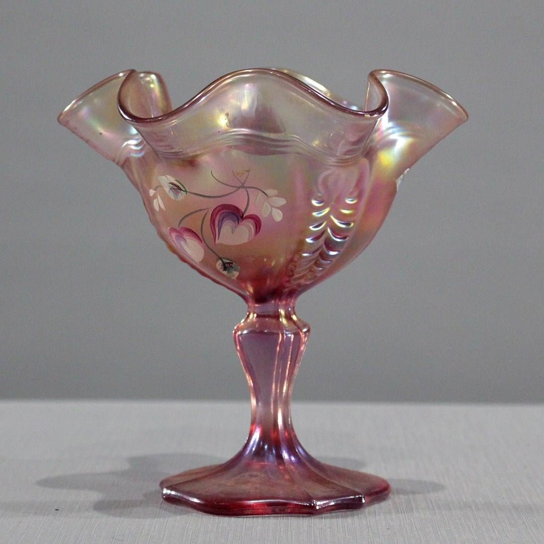 Fenton Glass Pink Compote Hand Painted Signed by Artist: Fenton Glass Pink Compote Hand Painted Artist Signed on base. Ruffled top with painted floral. Size: 6 in. height x 5.75 inches wide