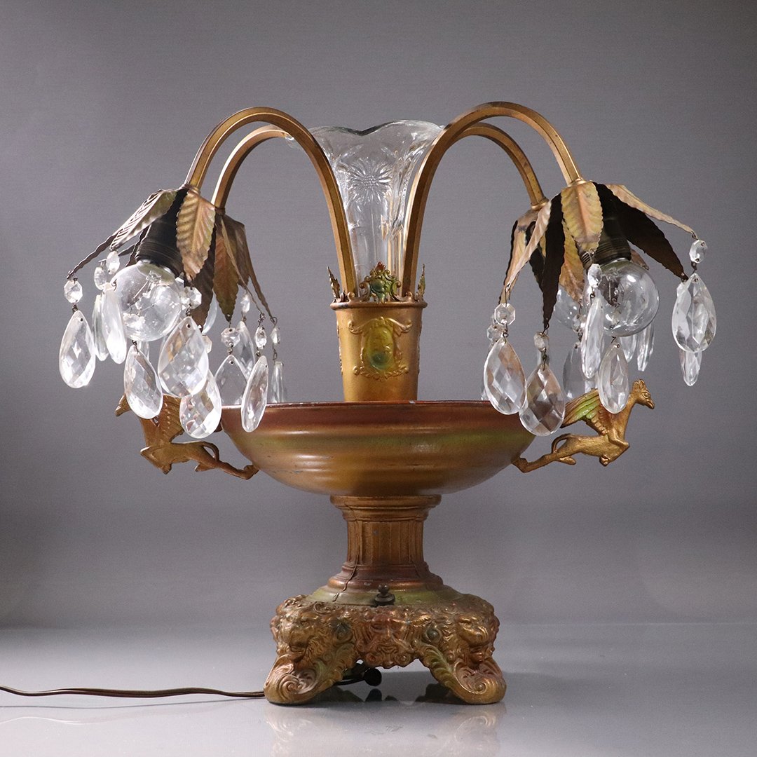 Circa 1920 Art Deco Fancy Metal Center Urn Table Lamp: Circa 1920 Art Deco Fancy Metal Center Urn Table Lamp. Glass Center Flower vase, 4 Lights, Bacchus faves on base, Pegasus handles. Original patina paint finish. Size: 16 in. height, 16 in. wide.