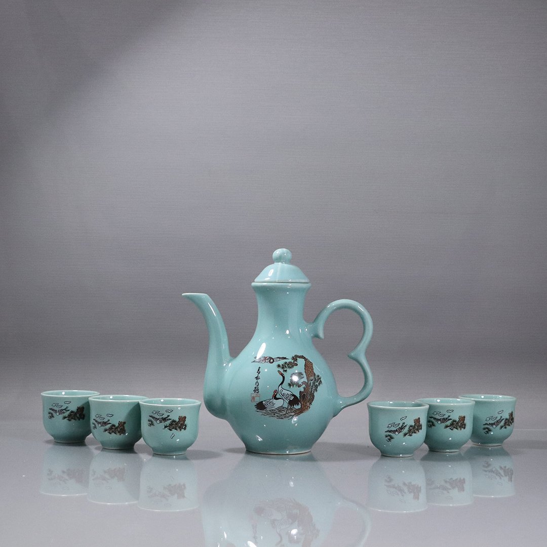 Oriental Porcelain Tea Set in Original Box: Oriental Porcelain Tea Set in Original Box. Teapot and 6 cups. Size: teapot 8 in. height, 7 in. wide, cups 2 in. height, 2.25 in. wide; box 11.5 in. x 8 in. x 4.5 in.