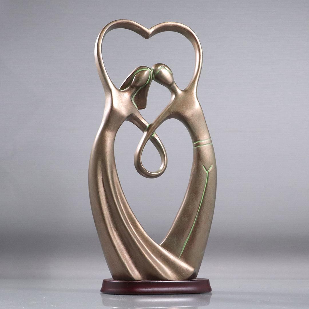 "Love" Sculpture Embracing Man and Woman: "Love" Sculpture Embracing Man and Woman. Made of a hard composition, original patina finish. size: 14h x 6.75w