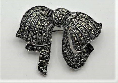 .925 Sterling Silver and Marcasites Ribbon Bow Brooch: .925 Sterling Silver and Marcasites Ribbon Bow Brooch. Marked: .925 ; Size: 1.75 in. x 1.5 in.