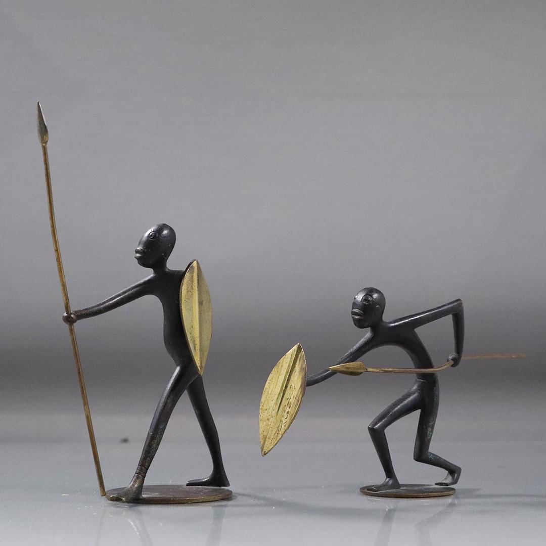 [2] HAGENHAUER Austria Bronze Figures Shields Spears: [2] HAGENHAUER Austria Bronze Figures Shields Spears. Mid-Century Modern. Signed on base. Good original patina finish. size: 6h x 2.5w, 3.5h x 6.5w