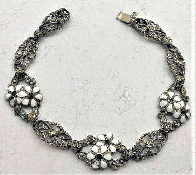 Sterling Silver Bracelet Marcasites White Enamel Flower: Sterling Silver Bracelet Marcasites White Enamel Flowers, black onyx center floral. Fancy Reticulated Pattern. size 7.5 in. length, 1/2 in wide