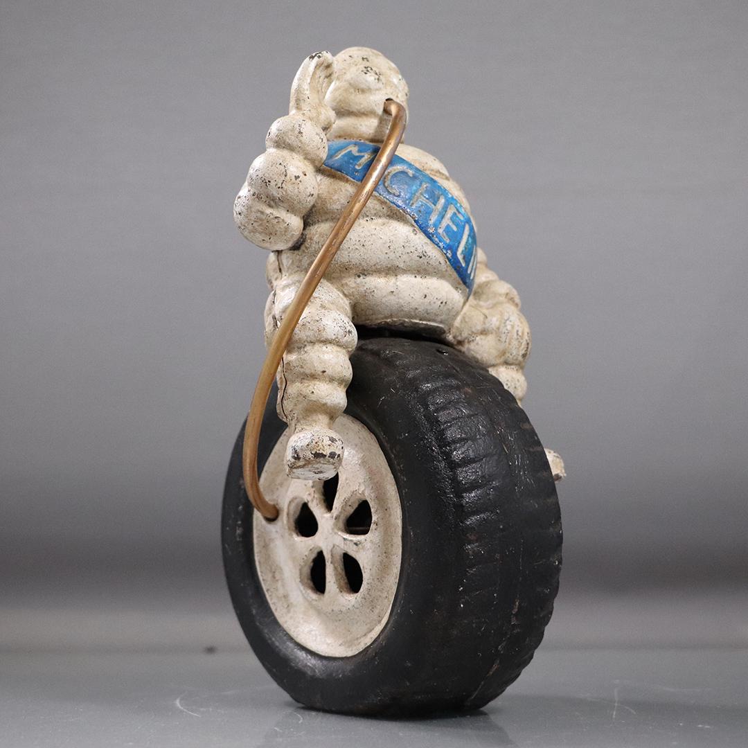Michelin Man Cast Iron Figure Sitting on Large Tire (1 of 6)