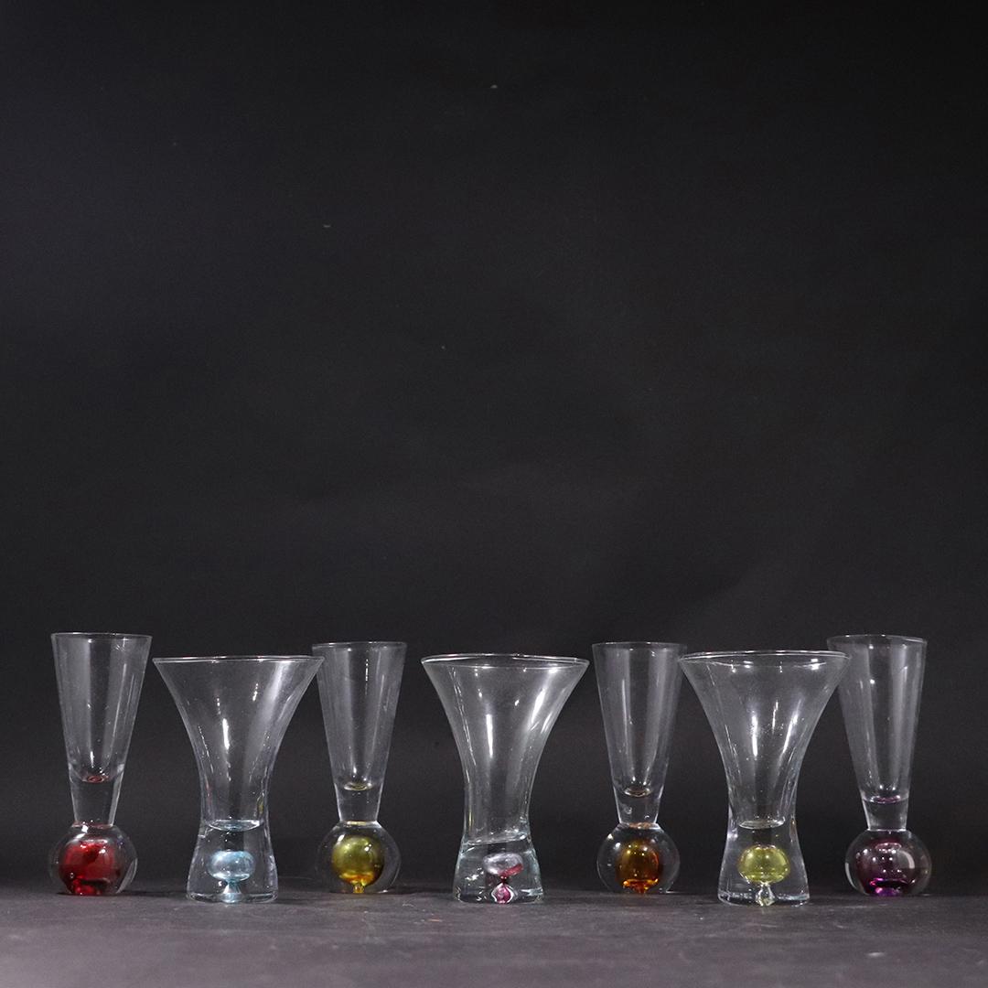 7 Mid-Century Shot Glasses Clear Color Weighted Bases: 7 assorted Mid-Century Shot Glasses Clear Color Weighted Bases. size: 4.25h x 3w, 4.75h x 1.75w.