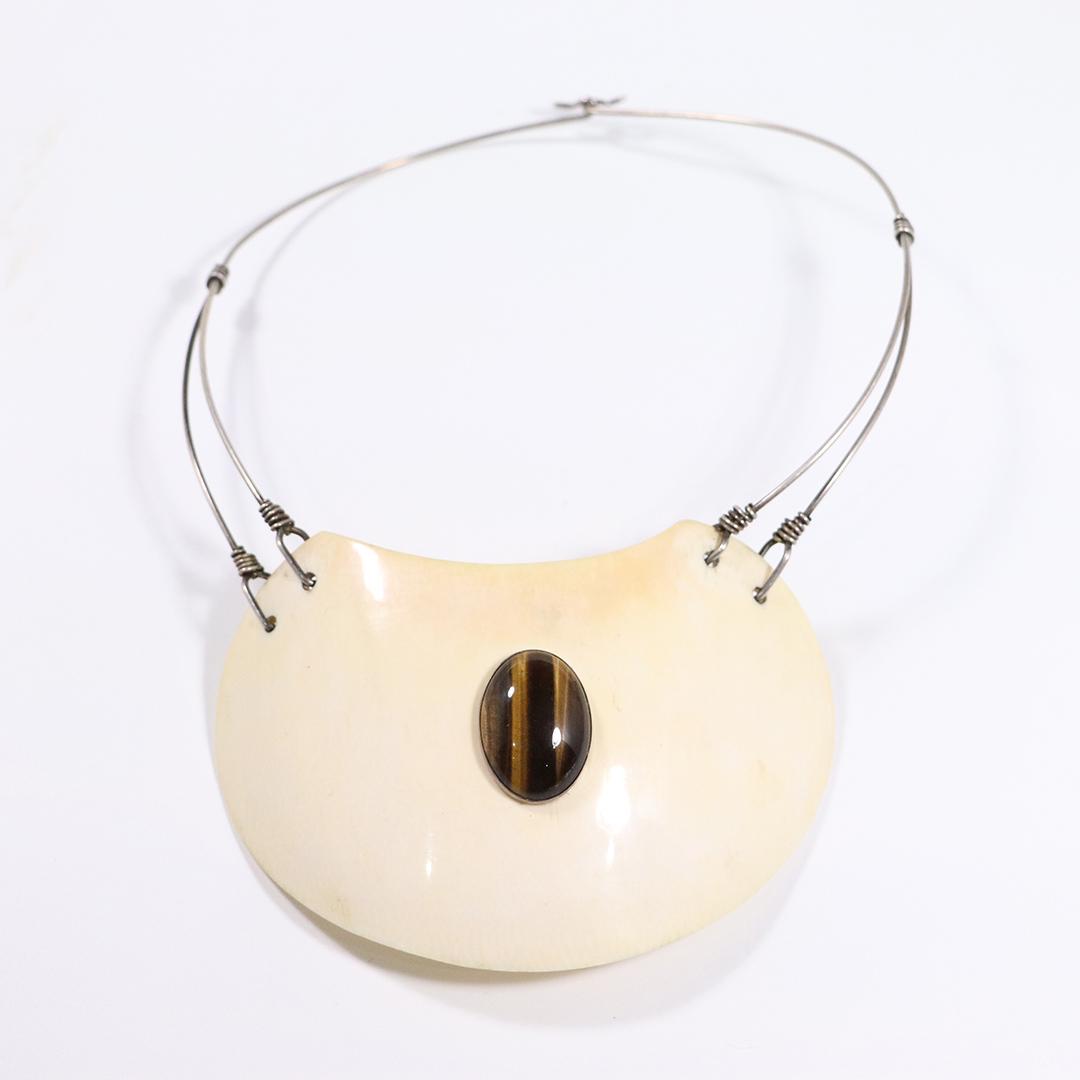 Fabulous Mid-Century Modern Necklace Polished Tiger Eye: Fabulous Mid-Century Modern Necklace Polished Tiger Eye mounted on a Polished Bone Plate, Sterling Silver Wire Necklace. Signed "V" carved into the bone plate. Size: plate 4 1/8 in. x 2.75 in.; tiger 