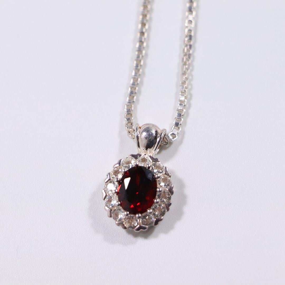 .925 Sterling Silver Garnet CZ Pendant Necklace: .925 Sterling Silver Garnet CZ Pendant Necklace. Size: pendant 7/8 in. x 1/2 in.; chain .925 Sterling 18 in. length