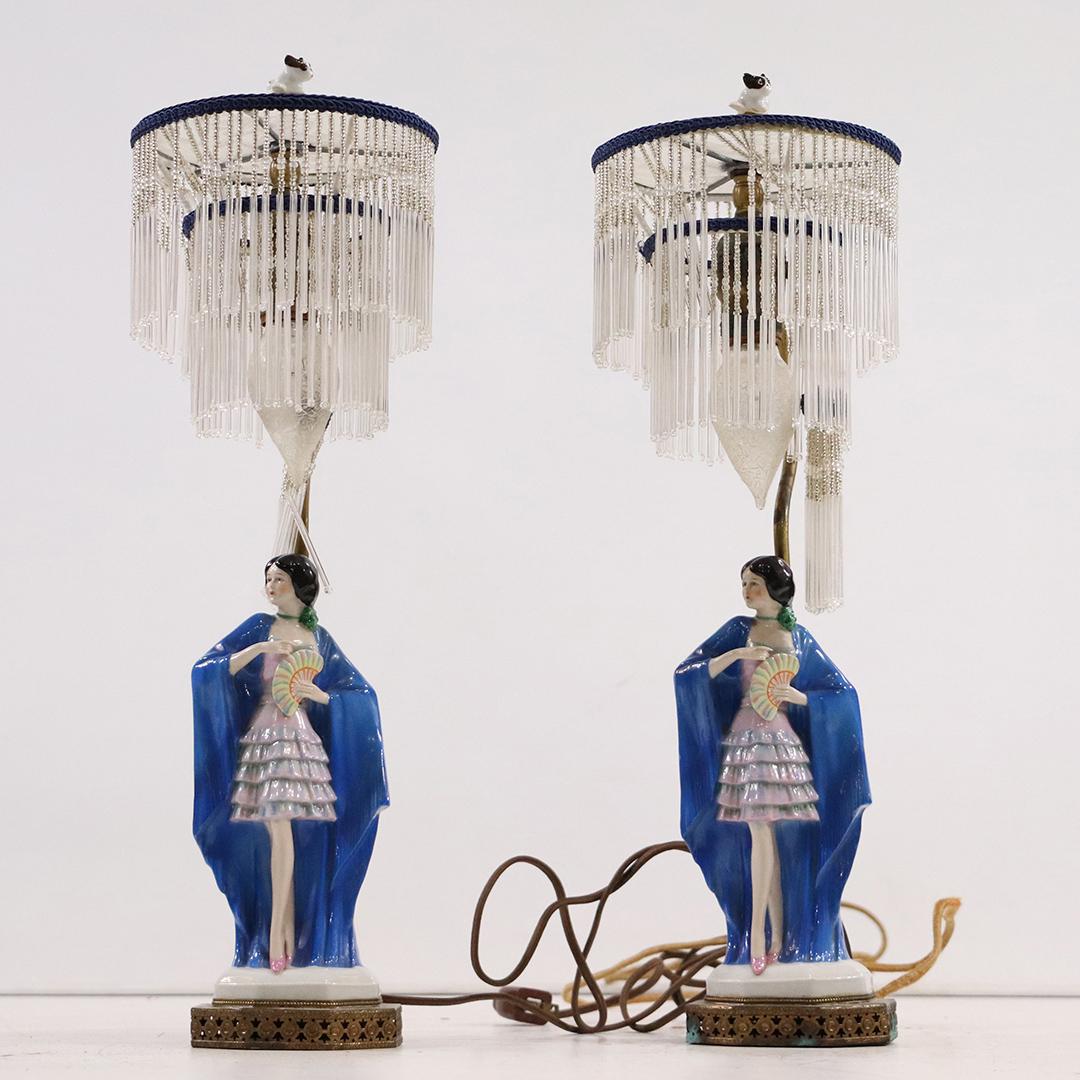 Pair Art Deco Porcelain Dancer Girl Lamps Beaded Shades: Pair Art Deco Porcelain Dancer Girl Lamps Beaded Shades. Nice quality. Dancers are holding a hand fan. Fine porcelain. Size: 20 x 6
