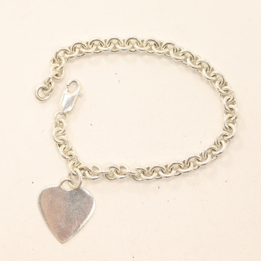 .925 Sterling Silver Bracelet with .925 Heart Charm: .925 Sterling Silver Bracelet with .925 Sterling Silver Heart Charm. Both marked: .925 ; size bracelet 7 in. x 1/4 in.; charm 3/4 in.