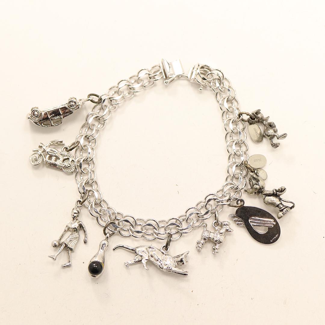 Sterling Silver Charm Bracelet with 9 Sterling Charms: Sterling Silver Charm Bracelet with 9 Sterling Charms. Size: 8 in. length x 3/8 in.