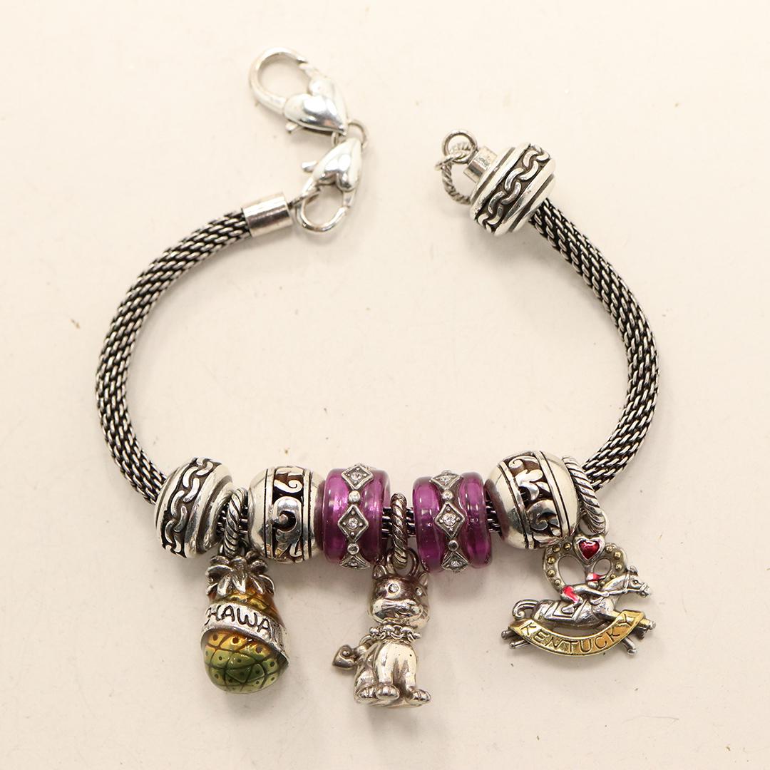 Sterling Silver Charm Bracelet with 9 Charms: Sterling Silver Charm Bracelet with 9 Charms, all test Sterling Silver. Size: 9 in. x 1/4 in.