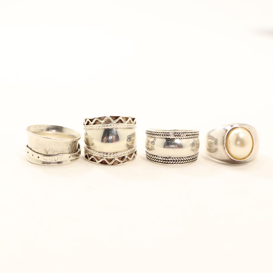 [4] Four .925 Sterling Silver Assorted Band Rings: [4] Four .925 Sterling Silver Assorted Band Rings. All marked: .925 ; All are ring size 7 ; braid band 3/4 in. x 1/2 in.; band with faux pearl 3/4 in. x 5/8 in.; Love band 3/4 in. x 1/2 in. ; Large ba