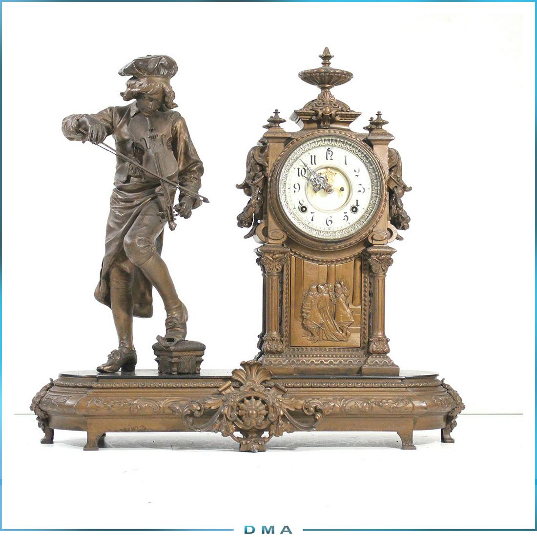 Ansonia Clock Co. Violinist Musician Figure Clock: Ansonia Clock Co. Violinist Musician Figure Clock , Antique Cast metal with a gold paint finish. Open escapement dial. Black Marble plateau base. Size: 21 in. height x 23 in. length