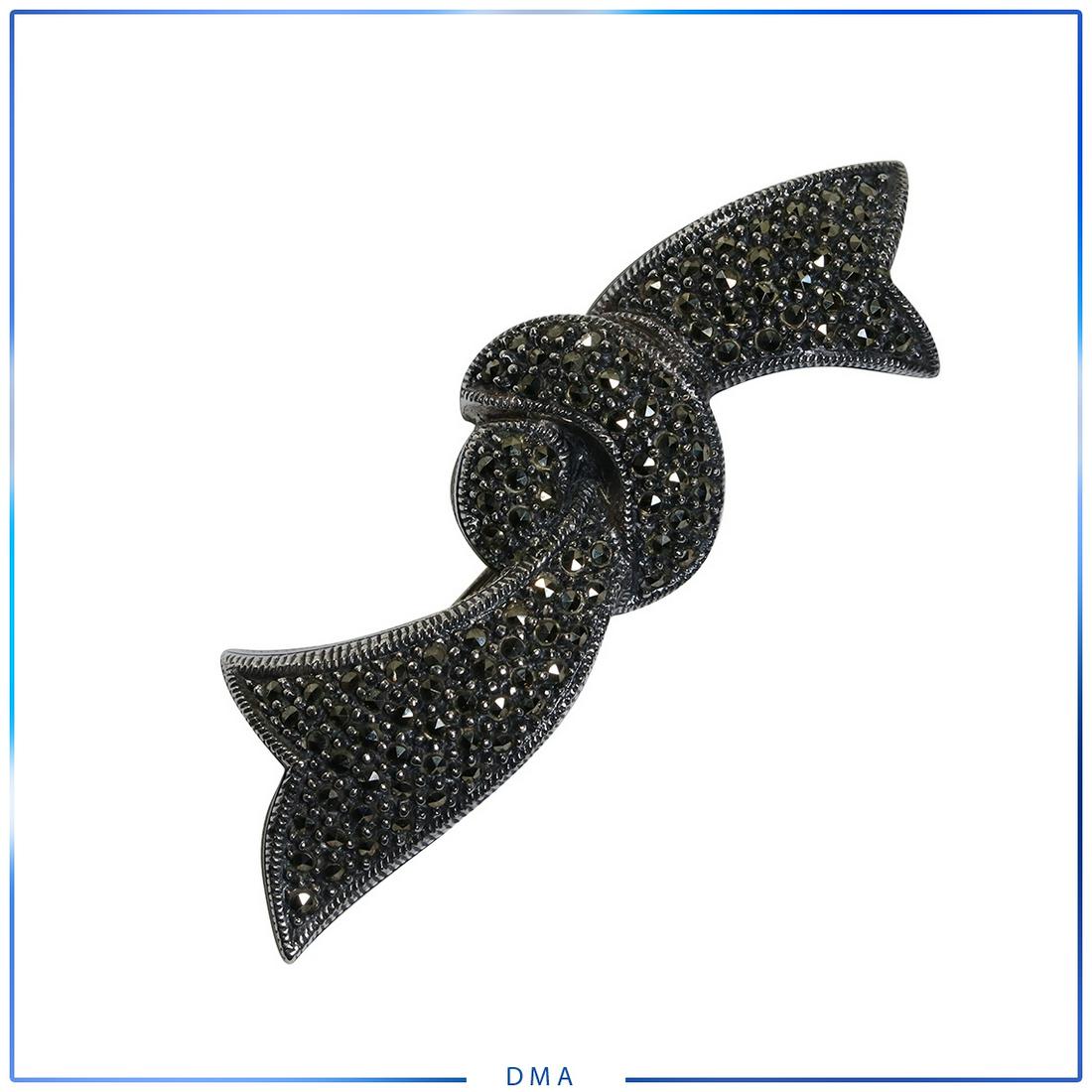Sterling Silver with Marcasites "Bow" Brooch: Sterling Silver with Marcasites "Bow" Brooch. Marked: Sterling. Size: 3 in. x 7/8 in.