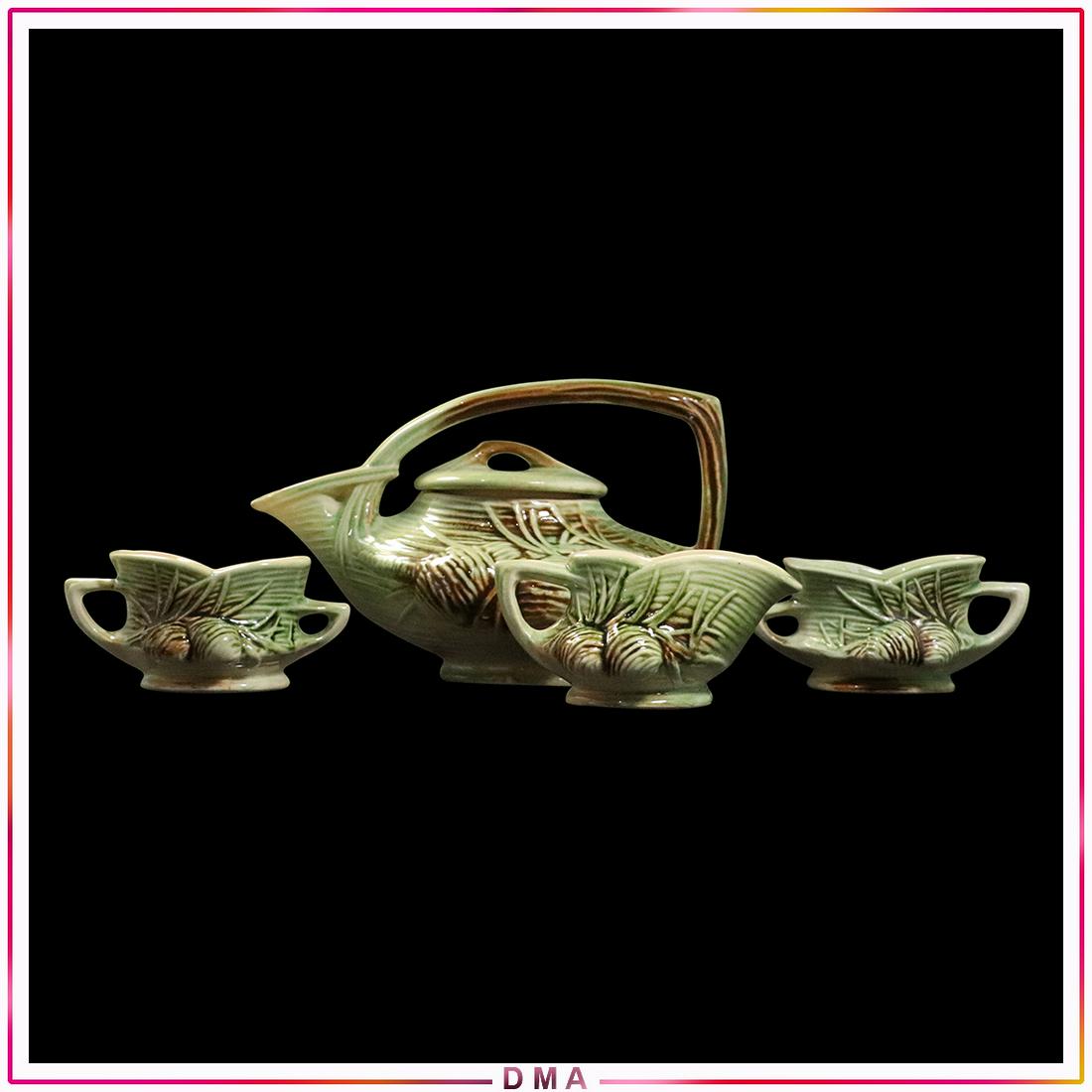 4 Pc. McCoy Pottery Pitcher, Creamer and 2 Sugar Bowls: 4 Pc. McCoy Pottery Pitcher, Creamer and 2 Sugar Bowls. Size: 6x10x7 pot, 3x6 creamer, 2.5x5.5x3.5 sugar