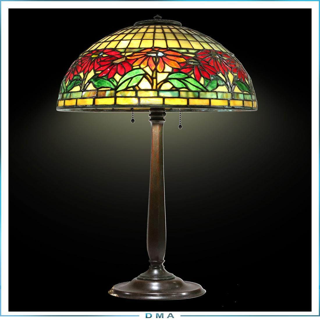 TIFFANY STUDIOS NEW YORK Poinsettia Lamp Signed: TIFFANY STUDIOS NEW YORK Poinsettia Lamp bears signature on shade and base. Leaded Glass Shade, Signed: Tiffany Studios New York; Bronze Base Signed and Numbered: Tiffany Studios New York #534. size: 