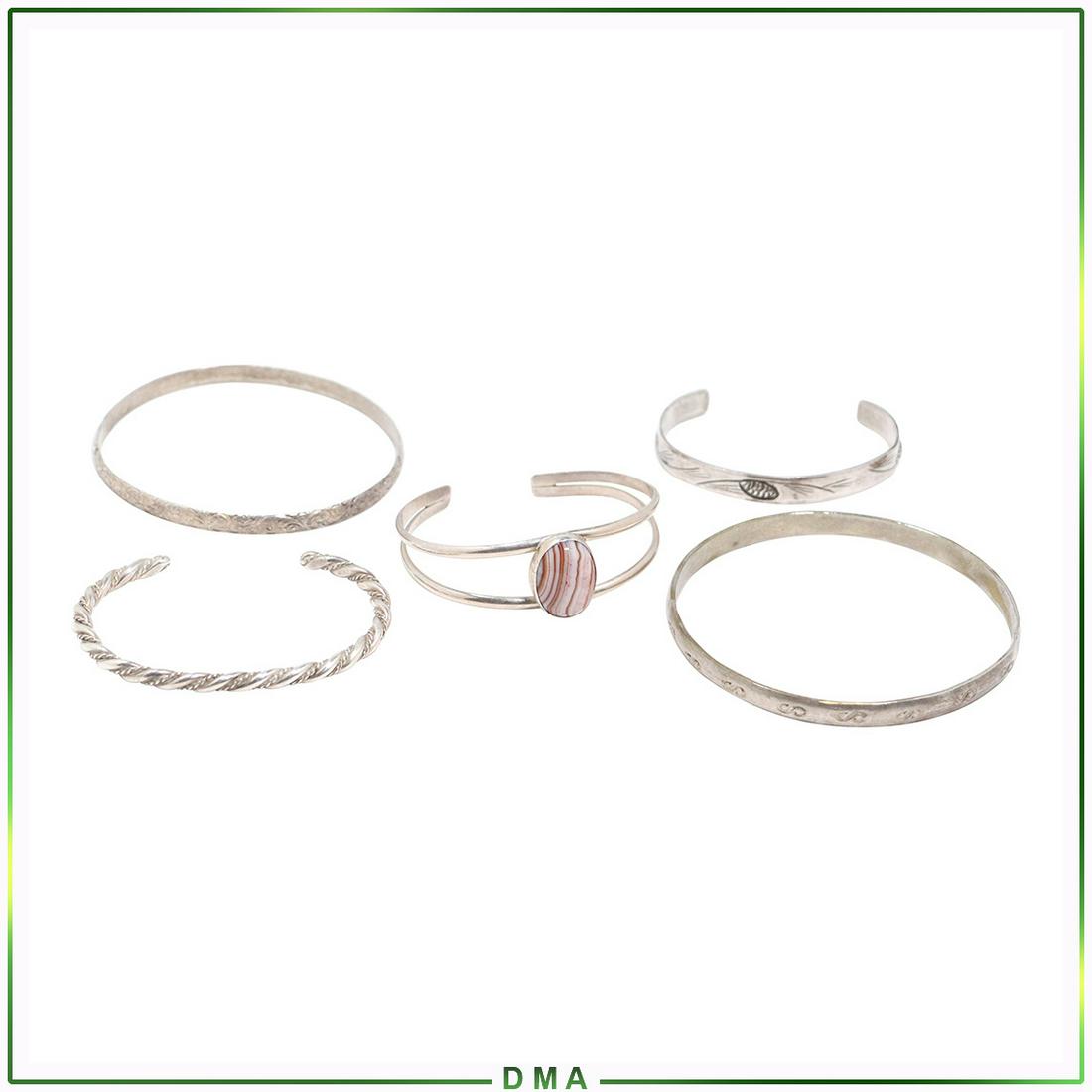 [5] Five Assorted Sterling Silver Bangle Cuff Bracelets: [5] Five Assorted Sterling Silver Bangle Cuff Bracelets. Marked: Sterling / Sterling Beau / Mexico / 2 test Sterling. size: small pinecone 2 in. x 1/4 in. ; swirl bangle 2 1/2 in. x 1/4 in. ; rope cuf