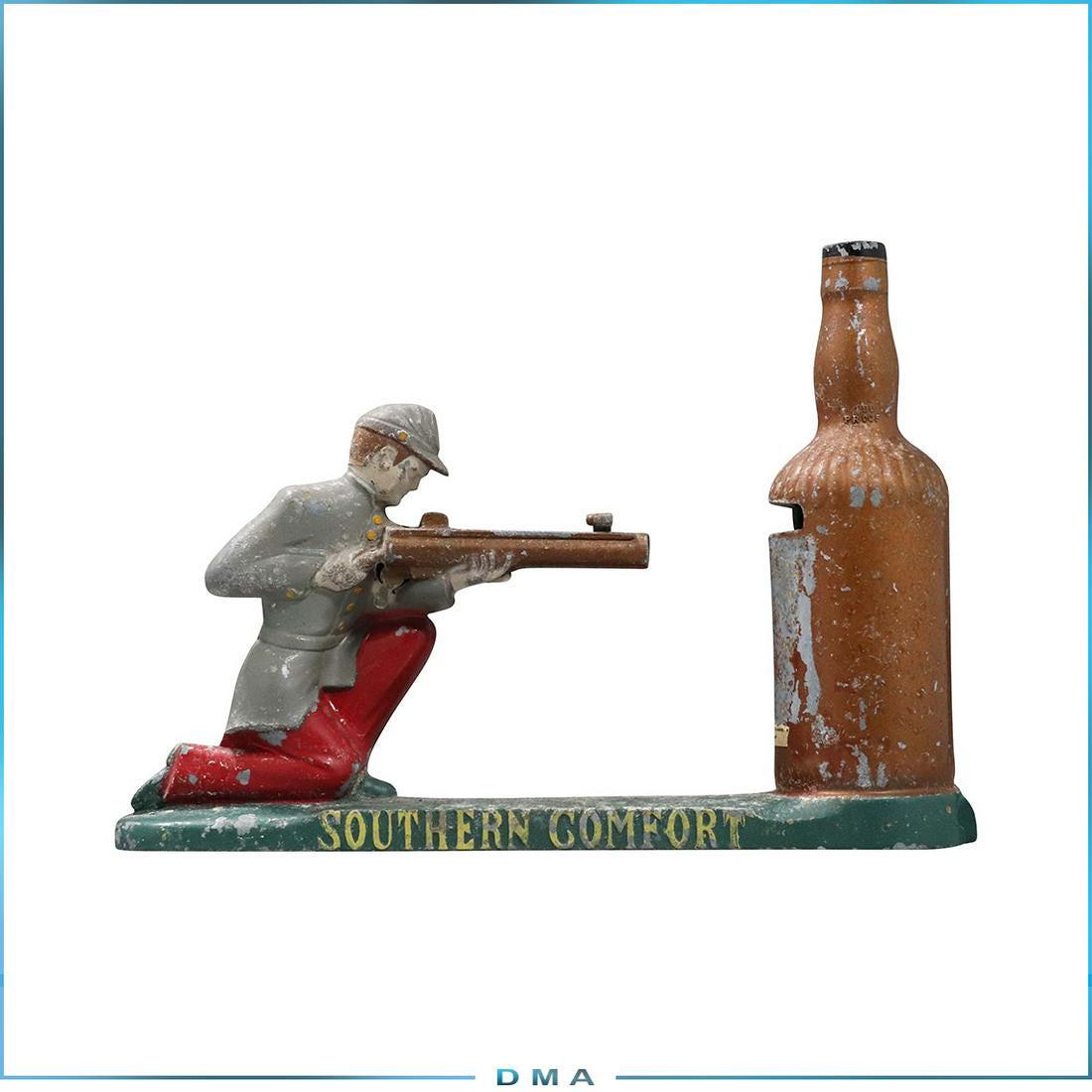 Southern Comfort Vintage Cast Metal Mechanical Bank: Southern Comfort Vintage Cast Metal Mechanical Bank. Bottle Shooter. Original paint finish. size: 6 in. height x 8.75 in. wide