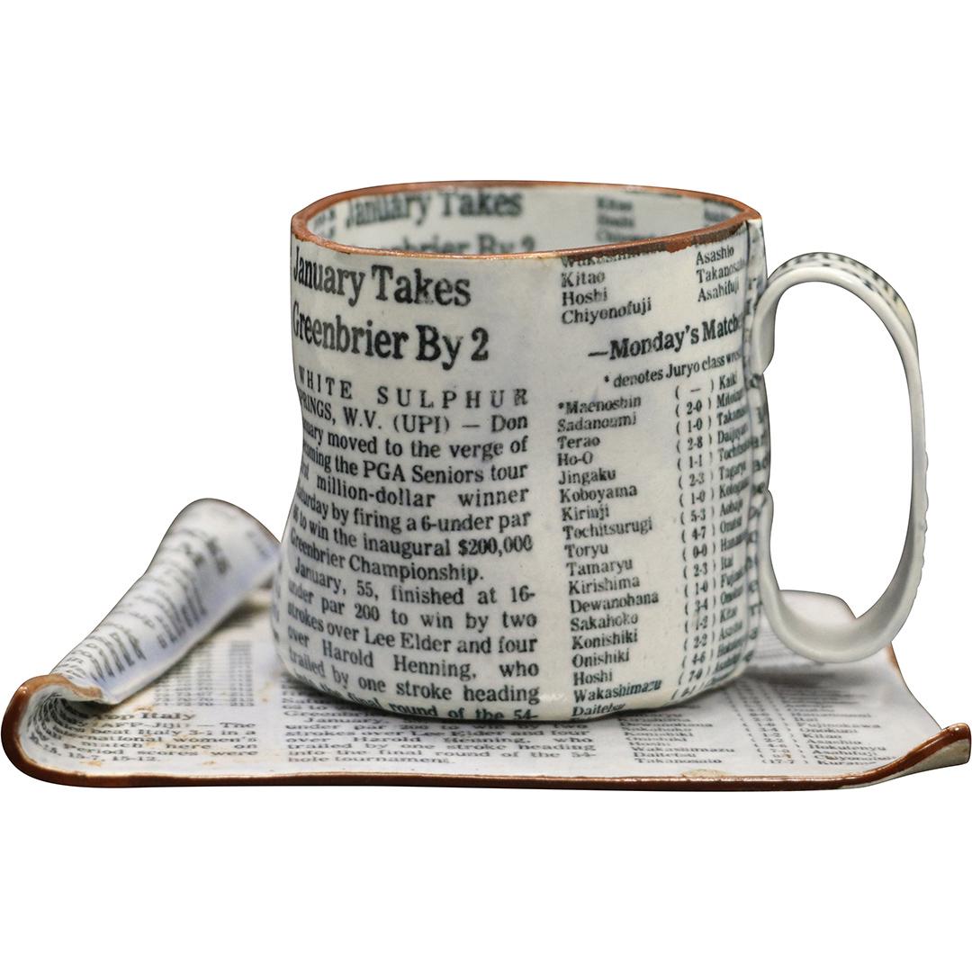 Shoko, Japanese Artist, Ceramic Newspaper Cup & Saucer: Shoko, Japanese Artist, Ceramic Newspaper Cup & Saucer sculpture Modern Design, Signed on base. Size: 2.5h x 3w mug, 4.75x4 saucer