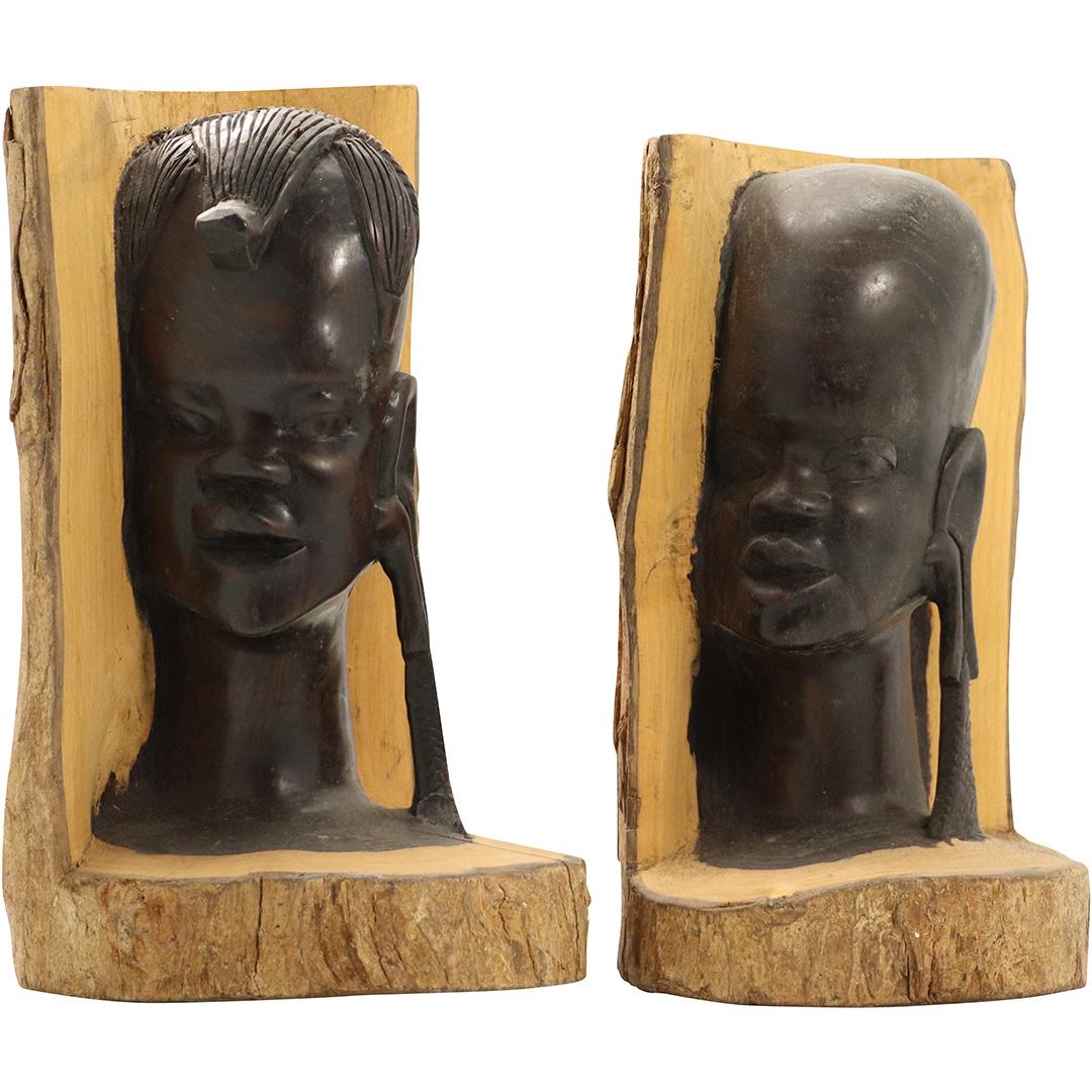 Carved African Teak Wood Portraits on Tree Bark Logs: Carved African Teak Wood Portraits on Tree Bark Logs Bookends. Size: 8.75h x 5w, 9.25h x 5.75w