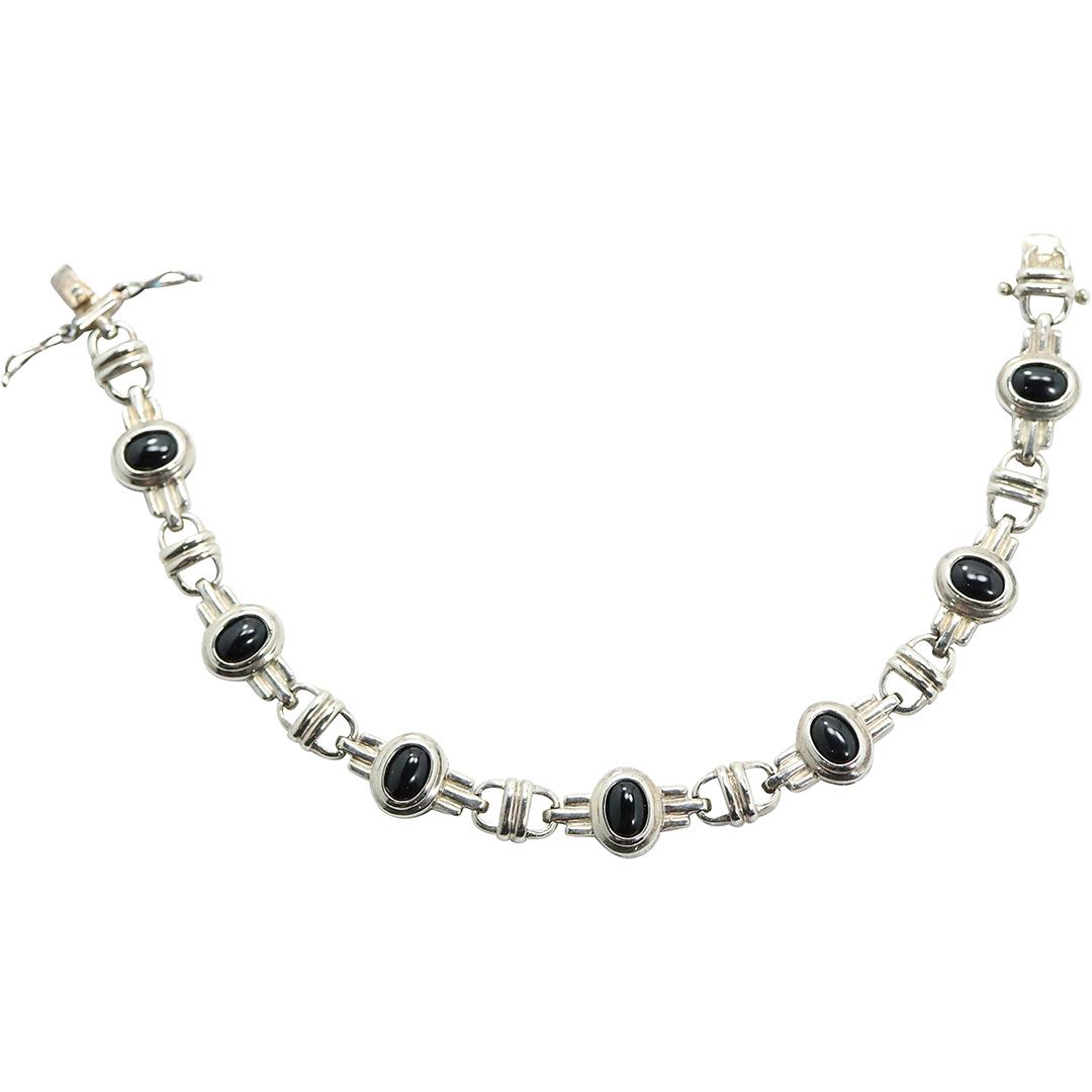 .925 Sterling Silver and Black Onyx Bracelet: .925 Sterling Silver and Black Onyx Bracelet. Marked: .925 ; size: 7 1/2 in. x 3/8 in.