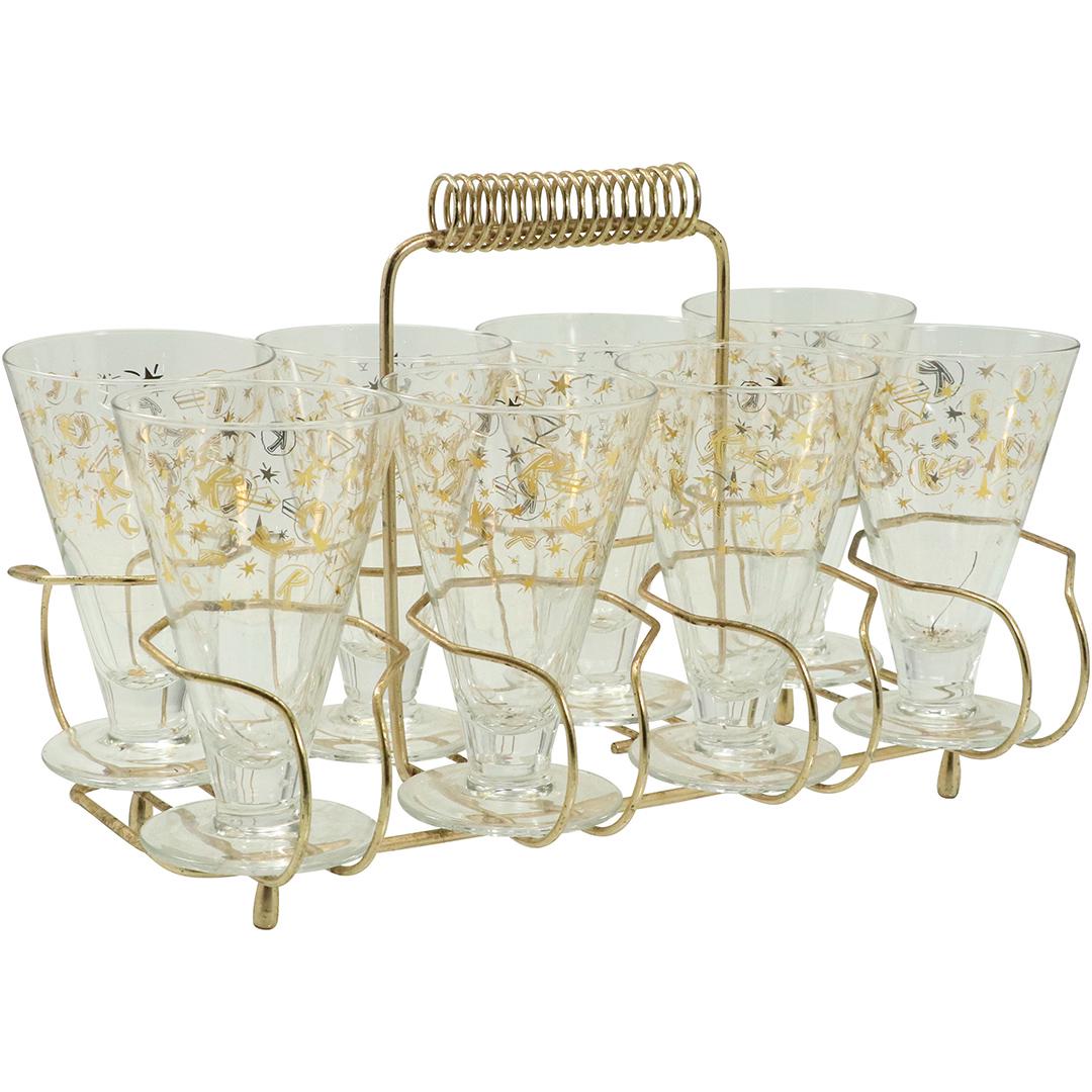 [8] Decorated Mid-Century Glasses in Metal Caddy: [8] Decorated Mid-Century Glasses in Metal Caddy, Circa 1950. Size: 5.25h x 3.5w glasses, 8.75h x 13L x 8.25w caddy