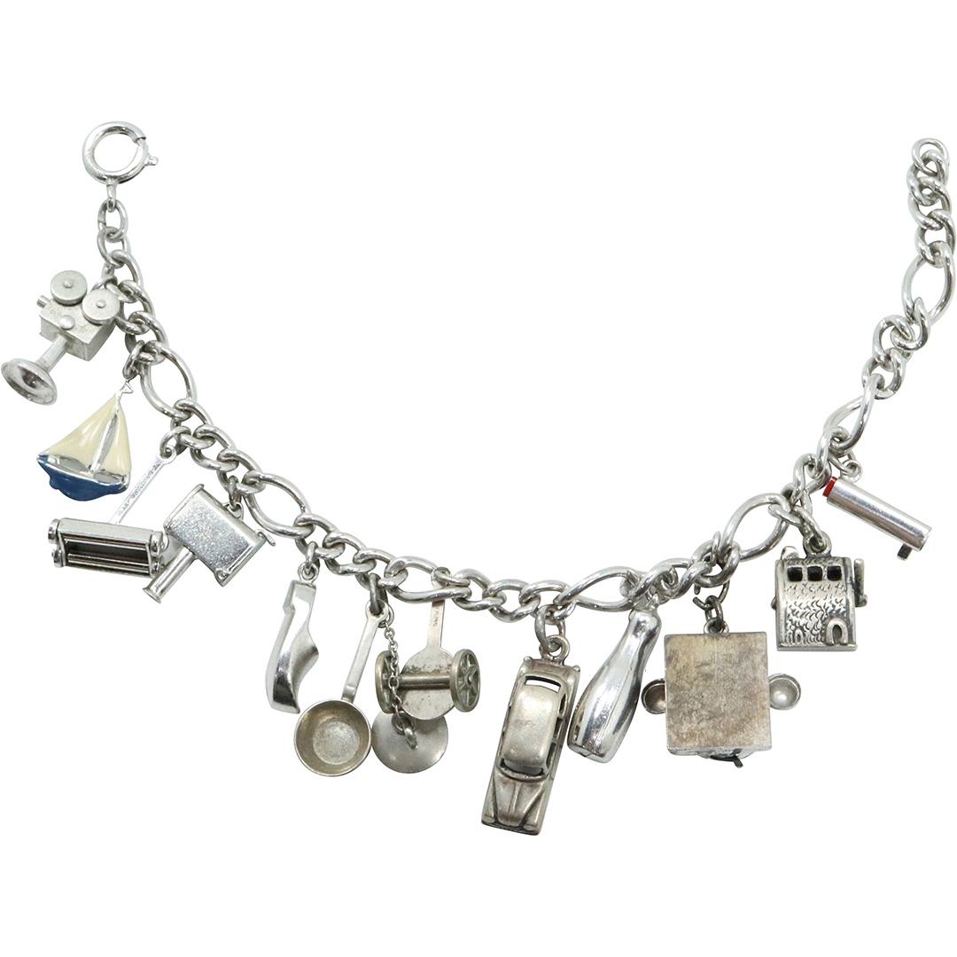 Sterling Silver Charm Bracelet with 12 Sterling Charms: Sterling Silver Charm Bracelet with 12 Sterling Charms. p> Size: 7 in. x 1/4 in.; charms 1/4 in. to 3/4 in.