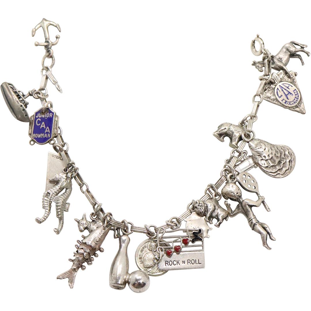 Sterling Silver Charms Bracelet with 17 Charms: Sterling Silver Charms Bracelet with 17 Charms. Marked: Sterling. Size: 8 in. x 1/8 in.