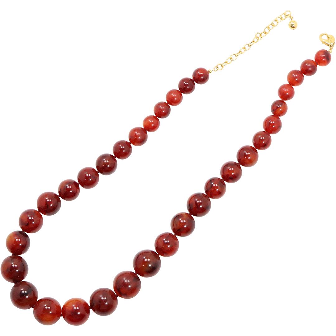 Joan Rivers Amber Lucite Necklace: Joan Rivers Amber Lucite Necklace; Graduated Beads. Size: 28 in. length; beads 1 in. to 1/2 in graduated sizes.