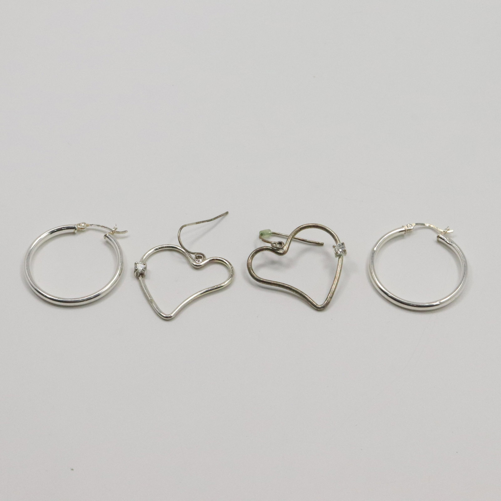 .925 Sterling Silver Hoop Earrings & Heart Earrings CZs: .925 Sterling Silver Hoop Earrings and Heart Earrings with CZs. Marked: .925 ; Size: hoops 1 1/4 in.; heart 1 1/8 in.