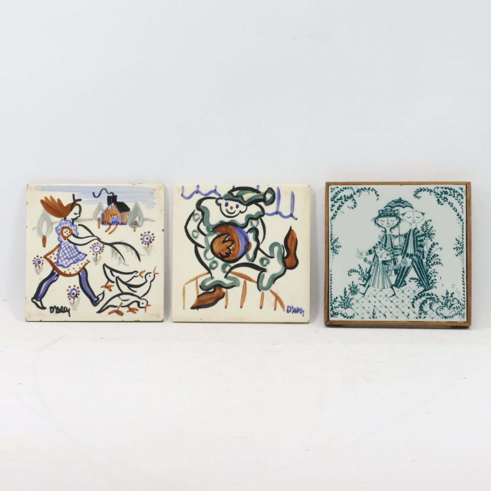 3 Danish Porcelain Tiles: Nymoe, D'Arcy, Bjorn Wiinblad: 3 Danish Porcelain Tiles: Nymoe, D'Arcy, Bjorn Wiinblad; size: (framed 1h 6.25w), (x2 .25h 6w)